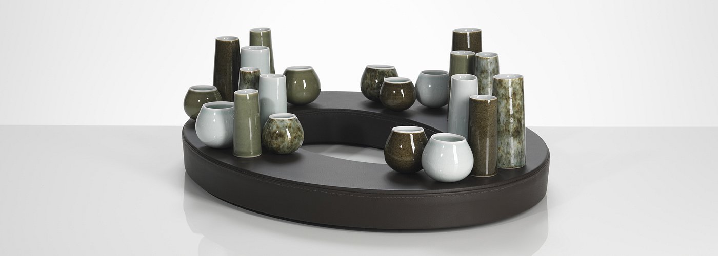 Extracurricular abode of stones iii comprising 21 pots and oval leather base.